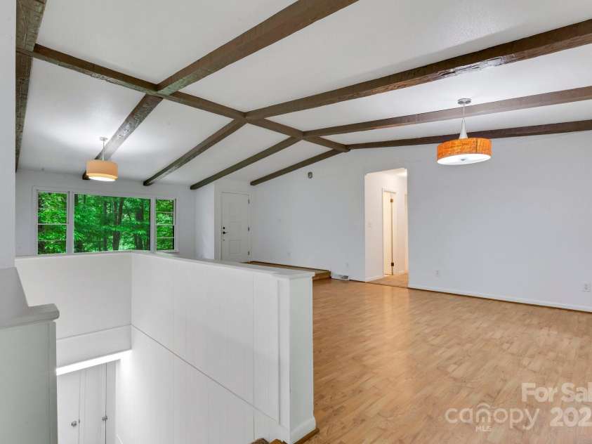 137 Flynn Branch Road, Asheville, NC 28804.  MLS# CAR4258132, YatesRealty ID 18863. Dining area and stairs to lower level