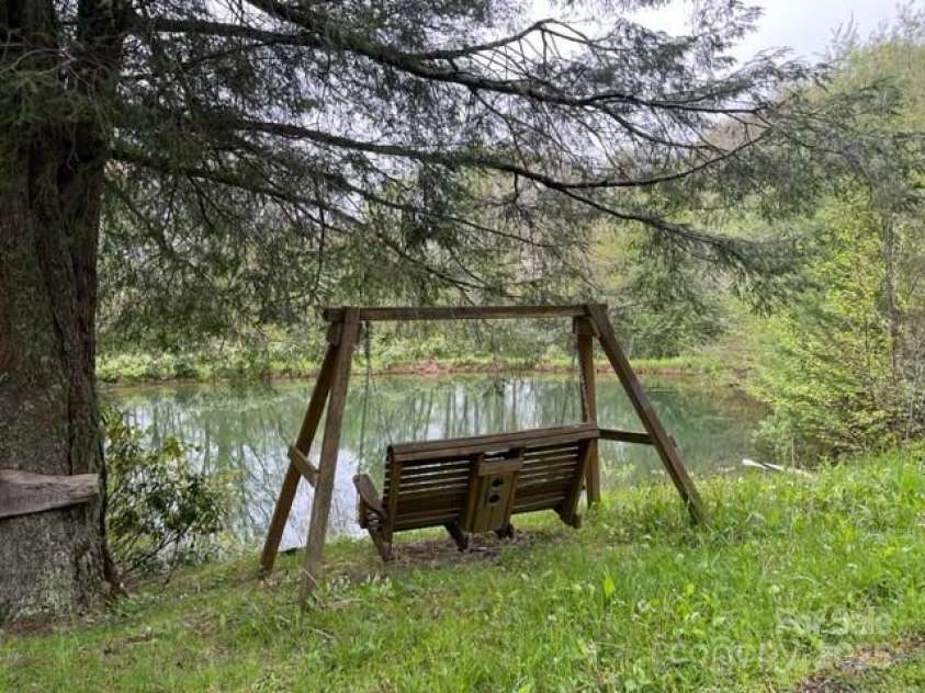 143 Daniel Boone Trail, Burnsville, NC 28714.  MLS# CAR4261449, YatesRealty ID 18872. Community pond right down the road