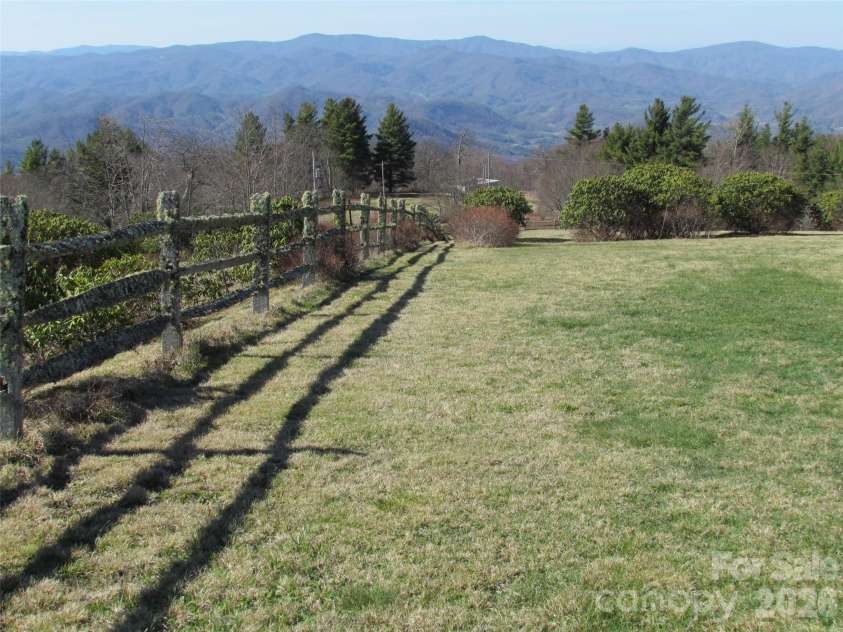 143 Daniel Boone Trail, Burnsville, NC 28714.  MLS# CAR4261449, YatesRealty ID 18872. Lot is partially surrounded by a charming split rail fence