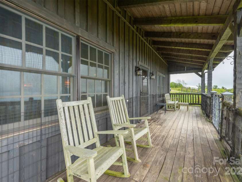 143 Daniel Boone Trail, Burnsville, NC 28714.  MLS# CAR4261449, YatesRealty ID 18872. Perfect rocking chair porch!
