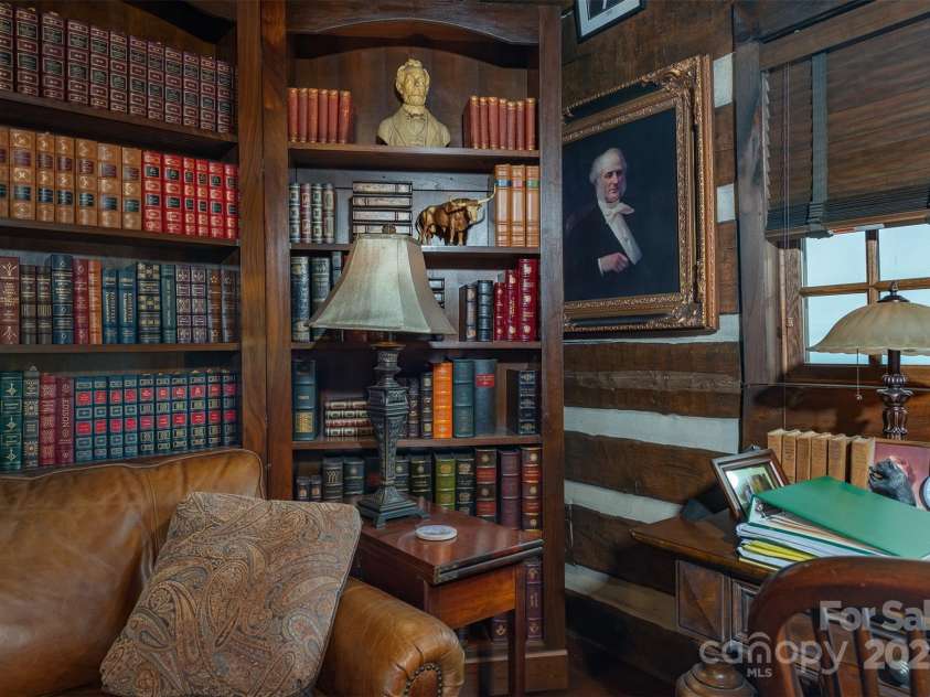 143 Daniel Boone Trail, Burnsville, NC 28714.  MLS# CAR4261449, YatesRealty ID 18872. Secret passageway with the bookcase