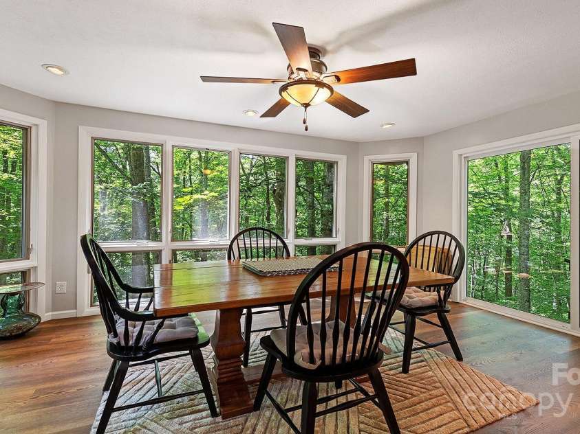 120 Blue Jay Loop, Maggie Valley, NC 28751.  MLS# CAR4242766, YatesRealty ID 18880. Gather 'round the table in this cozy dining nook, wrapped in peaceful woodland views.