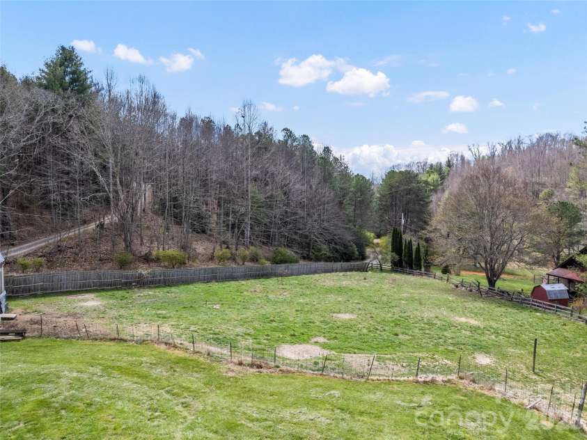 838 Hidden Valley Road, Clyde, NC 28721.  MLS# CAR4364695, YatesRealty ID 18881. Fenced in pasture and flat yard