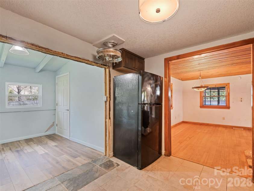 838 Hidden Valley Road, Clyde, NC 28721.  MLS# CAR4364695, YatesRealty ID 18881. Open flow from living to kitchen to primary suite
