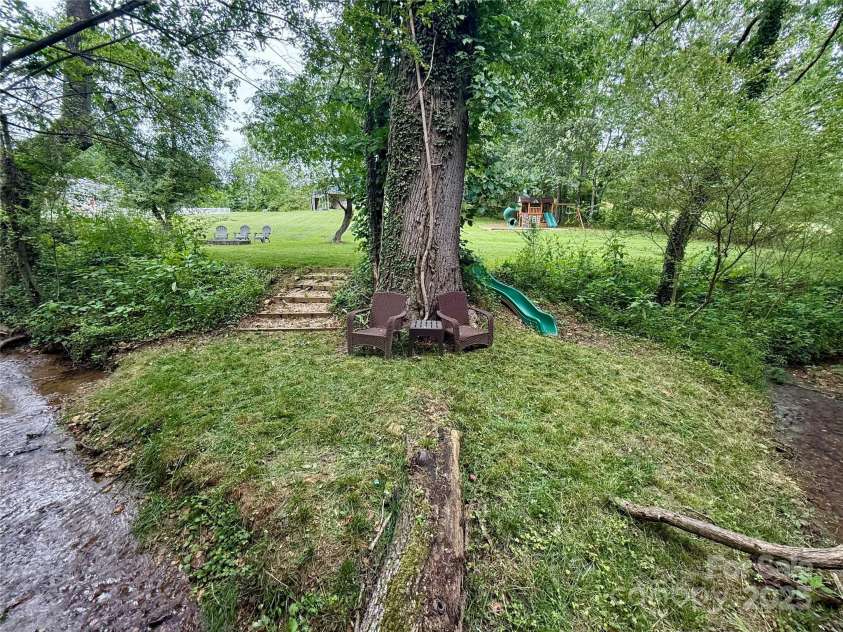 123 Dapple Road, Candler, NC 28715.  MLS# CAR4257282, YatesRealty ID 18892. Creek area in backyard