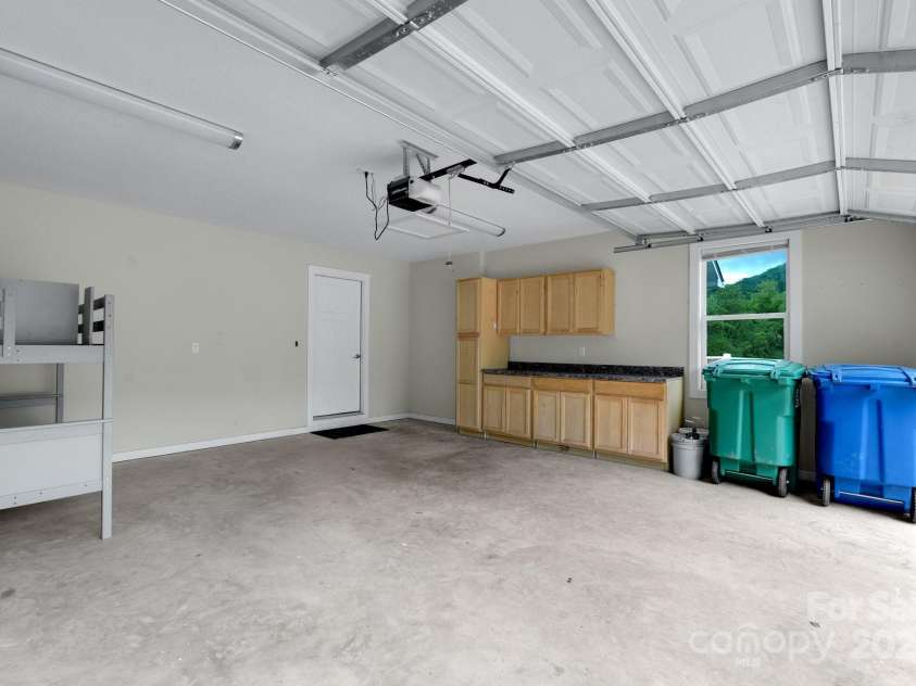 123 Dapple Road, Candler, NC 28715.  MLS# CAR4257282, YatesRealty ID 18892. Garage complete with workbench and storage