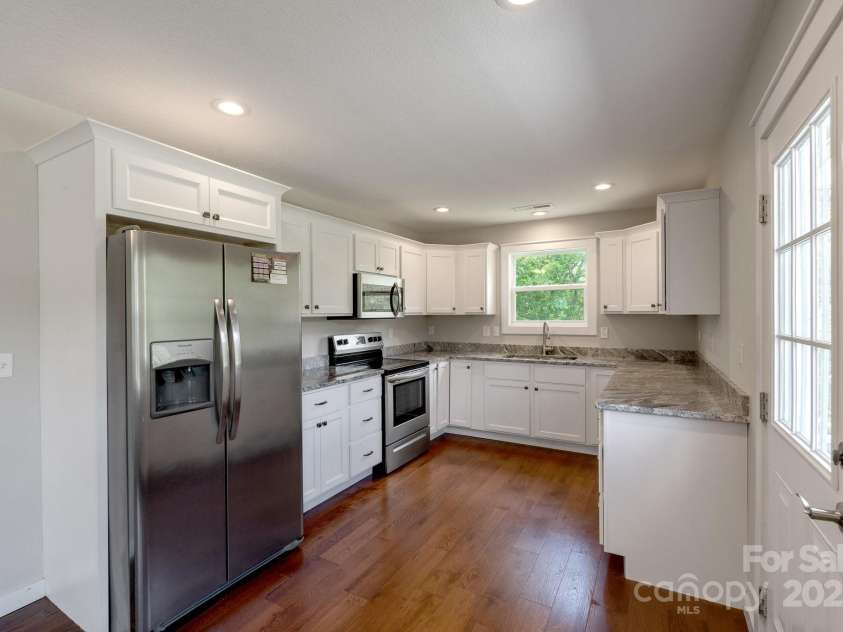 123 Dapple Road, Candler, NC 28715.  MLS# CAR4257282, YatesRealty ID 18892. Kitchen with views and door to wrap around porch