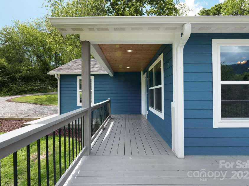 123 Dapple Road, Candler, NC 28715.  MLS# CAR4257282, YatesRealty ID 18892. Wrap around deck starts at front door
