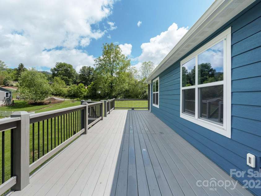 123 Dapple Road, Candler, NC 28715.  MLS# CAR4257282, YatesRealty ID 18892. Wrap around deck to the kitchen door