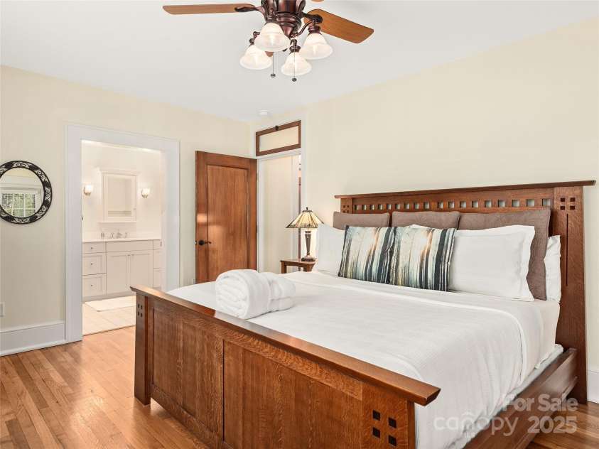 203 6th Avenue, Hendersonville, NC 28739.  MLS# CAR4288242, YatesRealty ID 18894. Primary bedroom suite. The attention to detail and architecture in this is what truly warms the space and the peace and quiet and money put into the noise reduction, yet being so close!