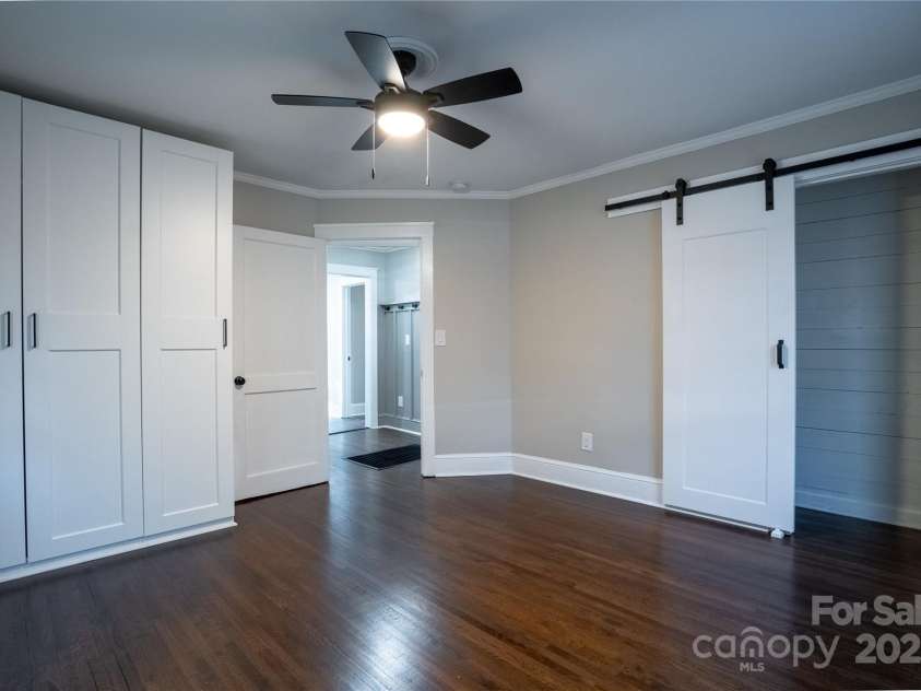 4429 Major Street, Charlotte, NC 28208.  MLS# CAR4243090, YatesRealty ID 18897. Primary Bedroom features built in wardrobe and additional barn door closet.