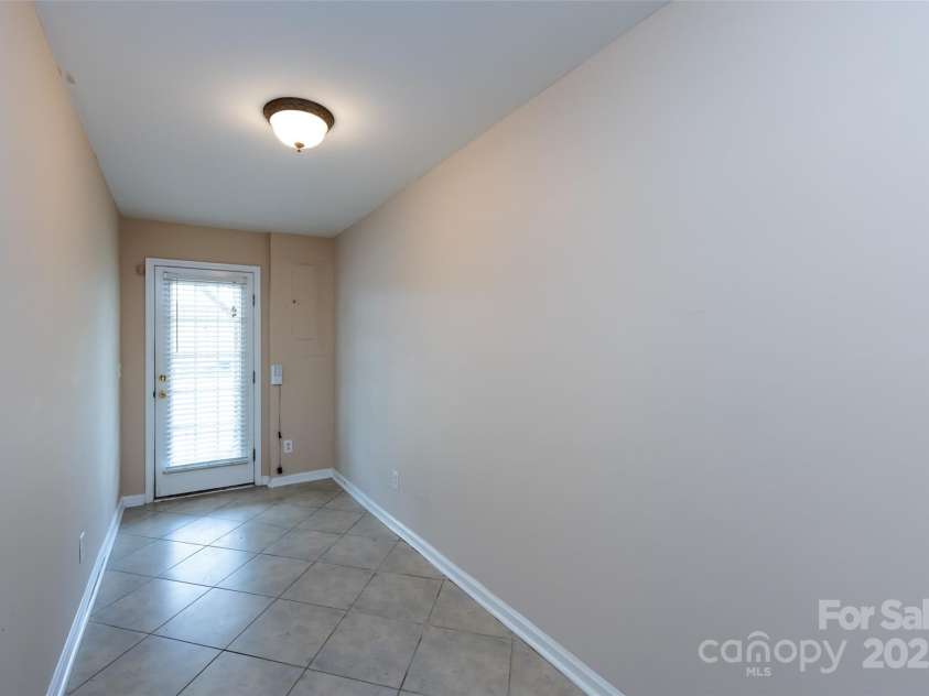 15623 Sir Charles Place, Charlotte, NC 28277.  MLS# CAR4257942, YatesRealty ID 18900. Hallway to Rear Door and Parking Pad