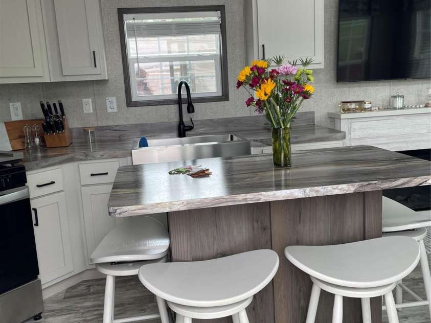 43 Vacation Pointe, Waynesville, NC 28785.  MLS# CAR4267523, YatesRealty ID 18903. Kitchen area with island counter and barstools