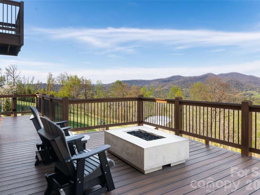 83 Cozy Mountain Lane, Weaverville, NC 28787.  MLS# CAR4368940, YatesRealty ID 18921. Deck off main level with fire pit