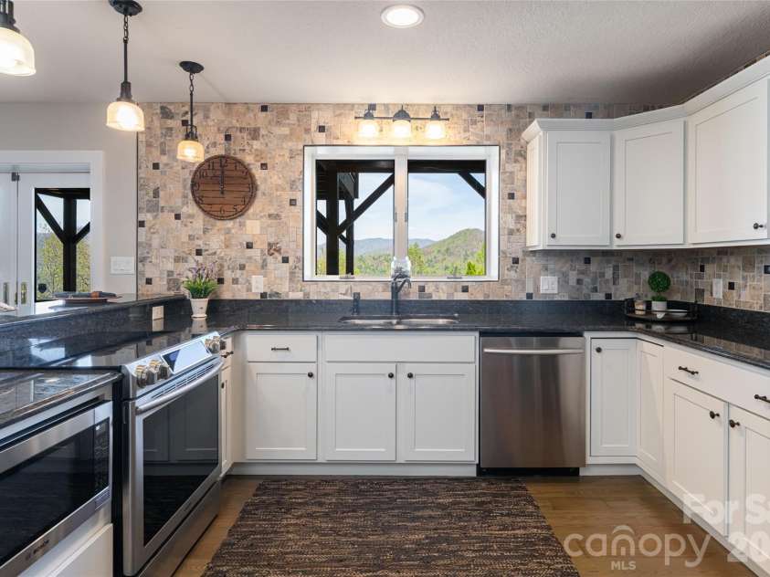 83 Cozy Mountain Lane, Weaverville, NC 28787.  MLS# CAR4368940, YatesRealty ID 18921. Lower level kitchen
