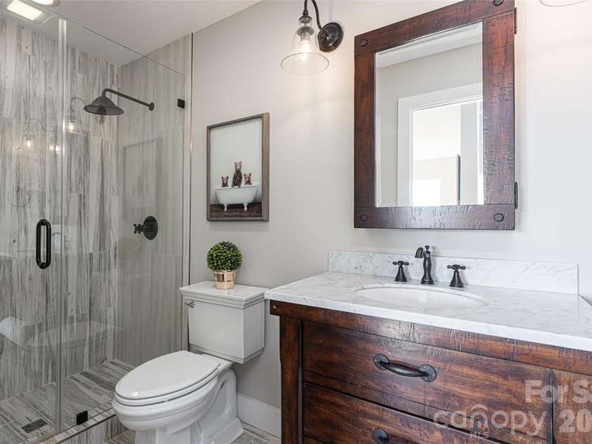 83 Cozy Mountain Lane, Weaverville, NC 28787.  MLS# CAR4368940, YatesRealty ID 18921. Upper level guest bathroom
