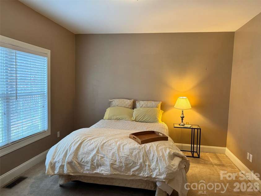 5006 Shannamara Drive, Matthews, NC 28104.  MLS# CAR4338291, YatesRealty ID 18925. Main level guest bedroom