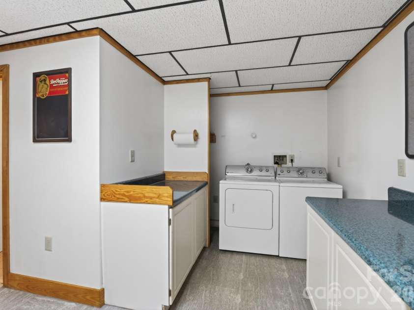5981 Johnson Road, Clover, SC 29710.  MLS# CAR4358157, YatesRealty ID 18926. Lower level - laundry room with lots of cabinets for storage or folding clothes - this spacious area could possibly be remodeled to add a small kitchenette - allowing this lower level to be muti-generational living