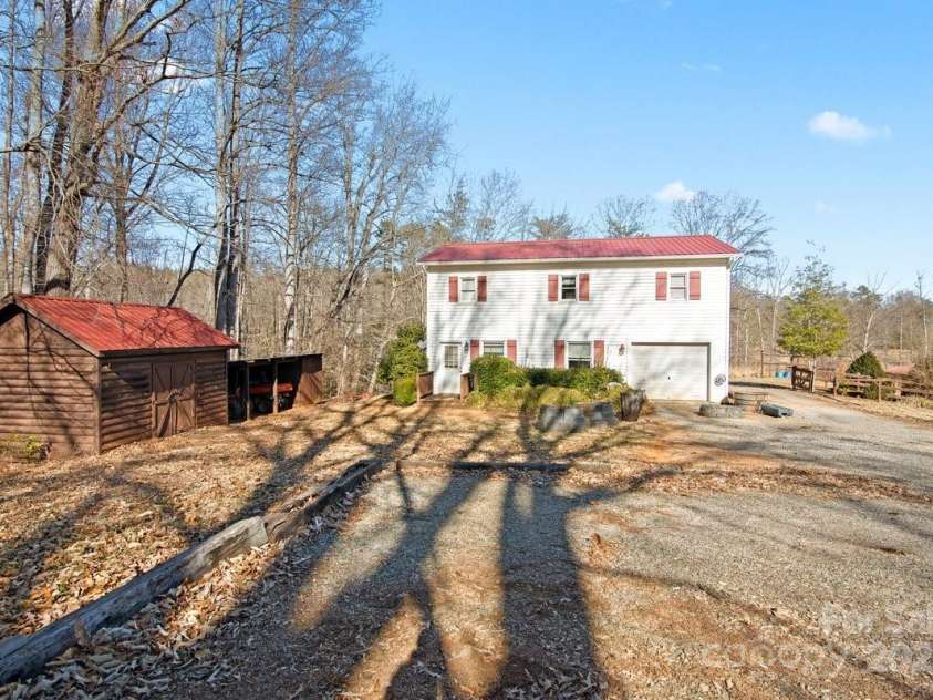 153 River Lane, Dobson, NC 27017.  MLS# CAR4233165, YatesRealty ID 1894. Shop with living quarters equiptment and tractor shed to the left