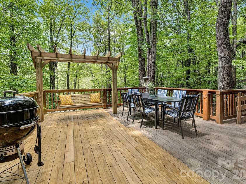 125 Pond Creek Road, Beech Mountain, NC 28604.  MLS# CAR4376008, YatesRealty ID 18951. Multiple deck areas idea for relaxing under the trees!