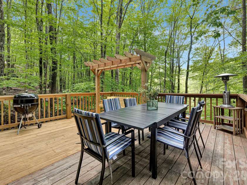 125 Pond Creek Road, Beech Mountain, NC 28604.  MLS# CAR4376008, YatesRealty ID 18951. Views from the deck showcase the forest canopy and filtered sunlight.