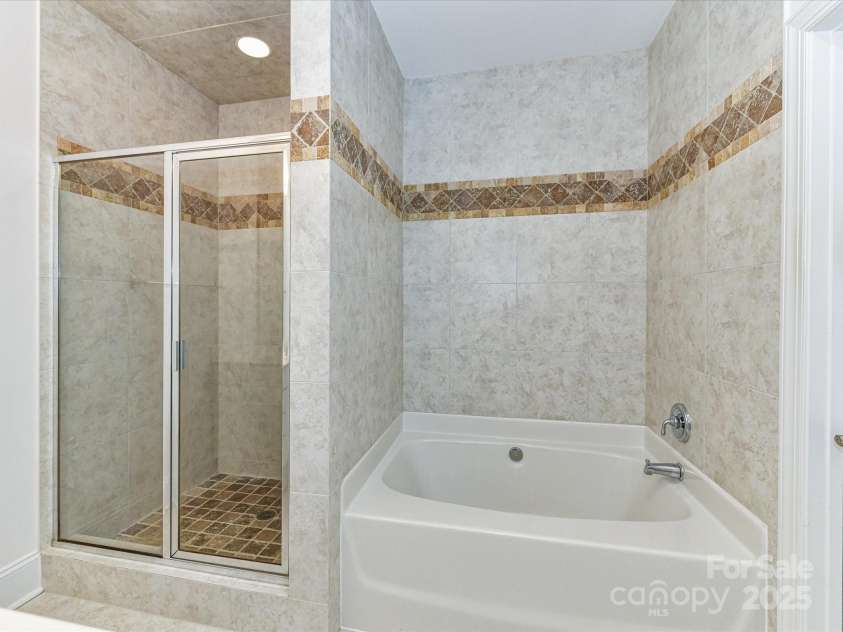 155 Harper Lee Street, Davidson, NC 28036.  MLS# CAR4328316, YatesRealty ID 18953. Large, walk-in tiled shower and soaking tub