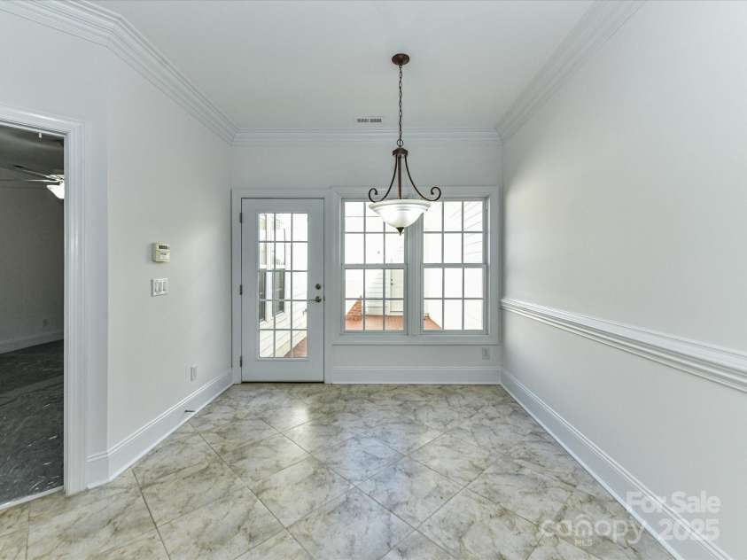 155 Harper Lee Street, Davidson, NC 28036.  MLS# CAR4328316, YatesRealty ID 18953. Rear entrance leads to the private patio and 2-car garage