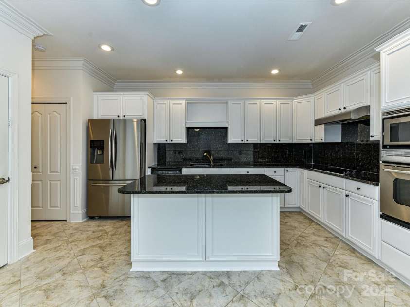 155 Harper Lee Street, Davidson, NC 28036.  MLS# CAR4328316, YatesRealty ID 18953. Spacious Kitchen with white cabinets and black granite