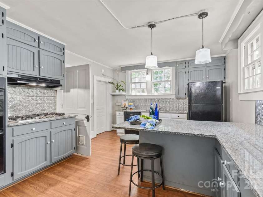 319 Oakland Street, Gastonia, NC 28052.  MLS# CAR4257720, YatesRealty ID 18955. Kitchen with Granite Counters and Lovely Backsplash