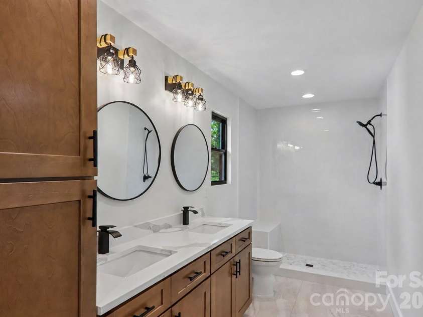 124 Main Street, Mars Hill, NC 28754.  MLS# CAR4375726, YatesRealty ID 18973. Primary bathroom with beautiful ceramic tile walk in shower with bench seating.