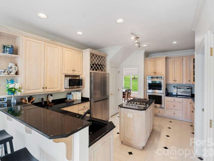 141 Grand Bay Drive, Mooresville, NC 28117.  MLS# CAR4364681, YatesRealty ID 18978. Bar seating, 2 sinks and 2 pantry's allow for function and storage