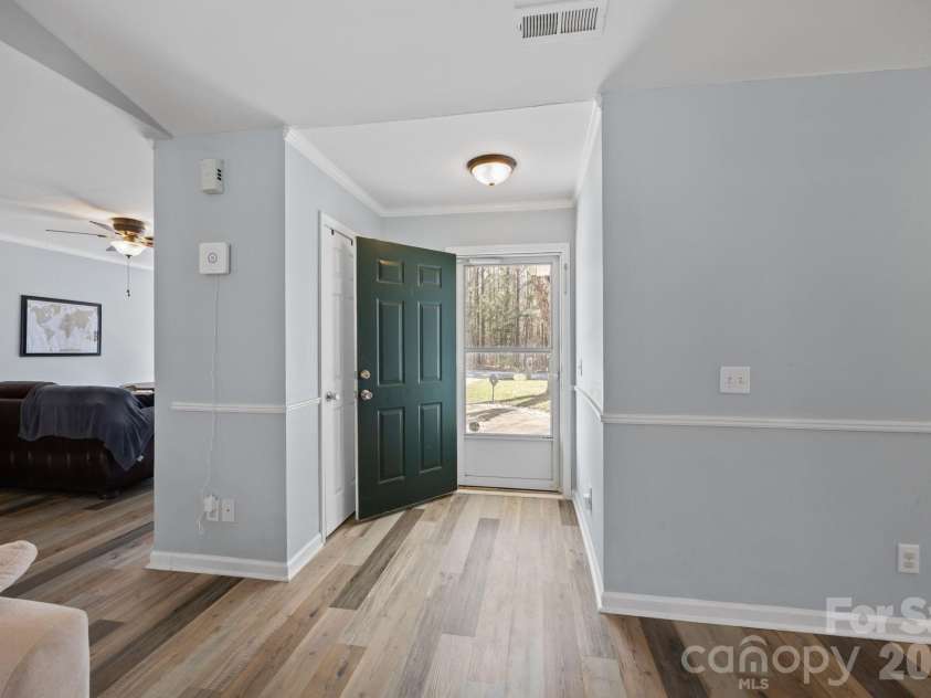 107 Panther Creek Road, Troutman, NC 28166.  MLS# CAR4356837, YatesRealty ID 18981. Bright and inviting entryway with updated flooring and an open-concept layout that leads directly into the expansive living & dining areas.