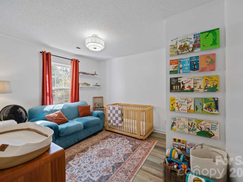 107 Panther Creek Road, Troutman, NC 28166.  MLS# CAR4356837, YatesRealty ID 18981. Charming secondary bedroom filled with natural light, featuring neutral tones and a spacious layout that easily adapts to your needs.