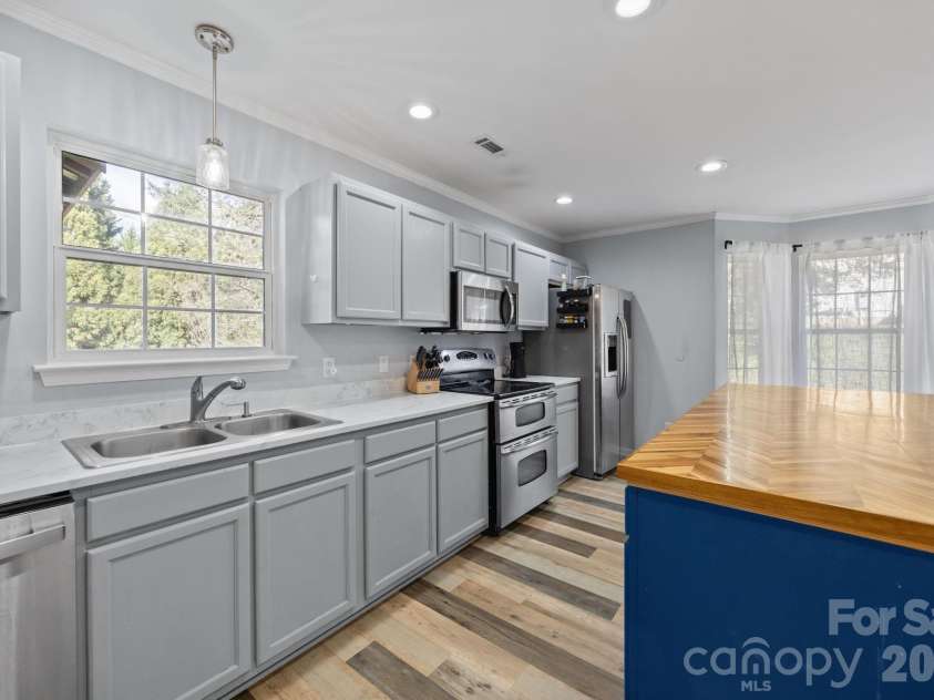 107 Panther Creek Road, Troutman, NC 28166.  MLS# CAR4356837, YatesRealty ID 18981. Spacious dining area perfectly integrated with the updated kitchen, offering a bright and airy atmosphere for everyday meals or formal hosting