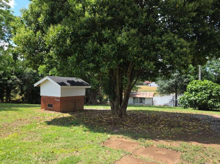 6006 White Store Road, Marshville, NC 28103.  MLS# CAR4256474, YatesRealty ID 18986. Side yard view looking towards back door neighbors pond