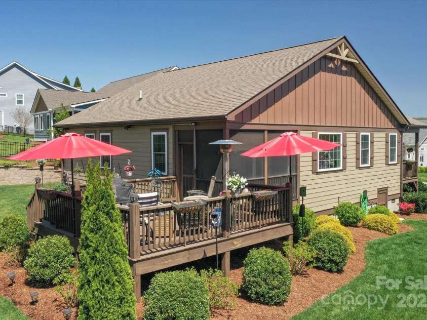 423 Blacksmith Run Drive, Hendersonville, NC 28792.  MLS# CAR4245571, YatesRealty ID 18989. An open deck plus a screened-in porch.