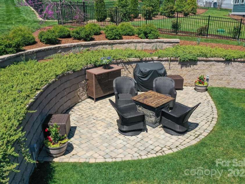 423 Blacksmith Run Drive, Hendersonville, NC 28792.  MLS# CAR4245571, YatesRealty ID 18989. Backyard patio with fire pit, seating, and electricity.