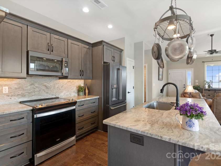 423 Blacksmith Run Drive, Hendersonville, NC 28792.  MLS# CAR4245571, YatesRealty ID 18989. Hanging utensil rack over kitchen island.