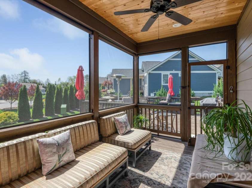 423 Blacksmith Run Drive, Hendersonville, NC 28792.  MLS# CAR4245571, YatesRealty ID 18989. The screened porch has shades that lower for privacy and sun relief.