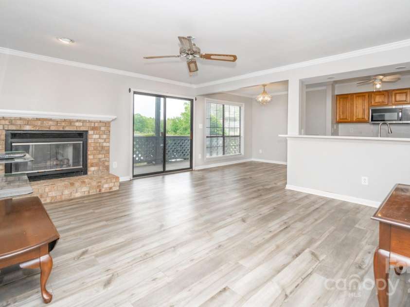 5833 Harris Grove Lane, Charlotte, NC 28212.  MLS# CAR4254761, YatesRealty ID 19011. Family room looking into dining area and kitchen pass through