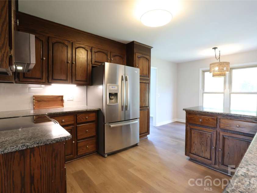 12809 Pine Bluff Road, Midland, NC 28107.  MLS# CAR4374117, YatesRealty ID 19012. Kitchen breakfast bar area is open to breakfast area.