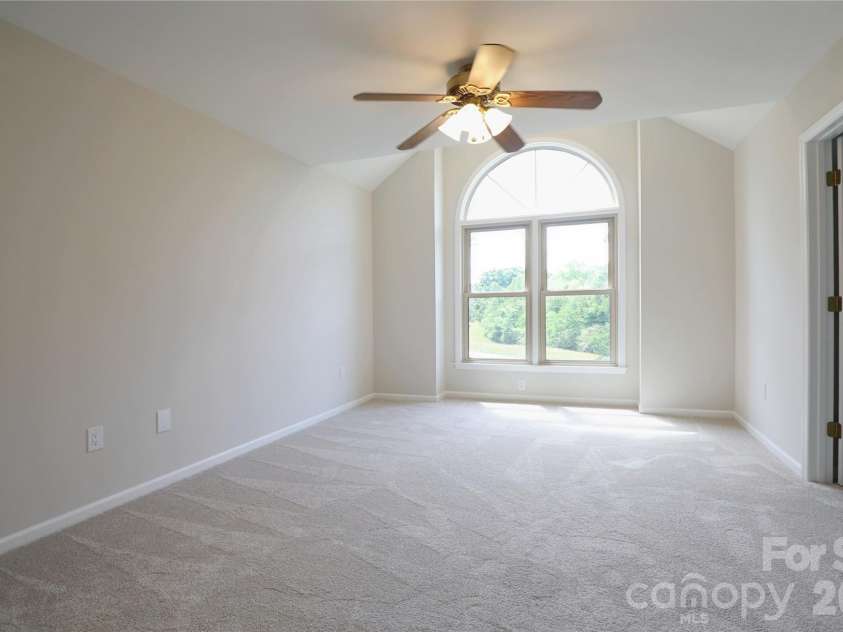 12809 Pine Bluff Road, Midland, NC 28107.  MLS# CAR4374117, YatesRealty ID 19012. Primary bedroom with vaulted ceiling at window has new carpet.
