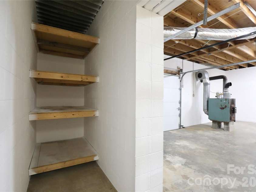 12809 Pine Bluff Road, Midland, NC 28107.  MLS# CAR4374117, YatesRealty ID 19012. Shelving storage area off basement.