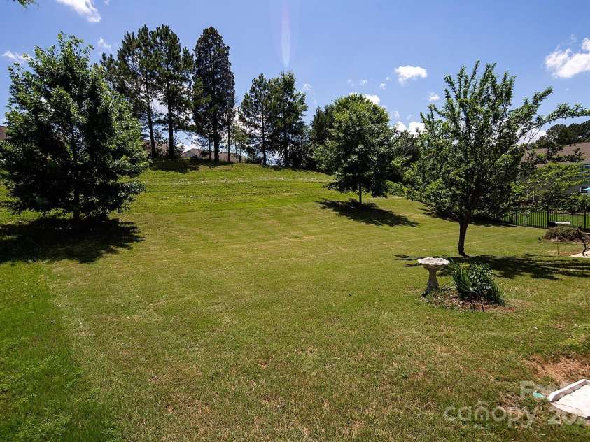 10792 Elsfield Avenue, Concord, NC 28027.  MLS# CAR4261572, YatesRealty ID 19040. HOA owned beyond the trees and mowed regularly!