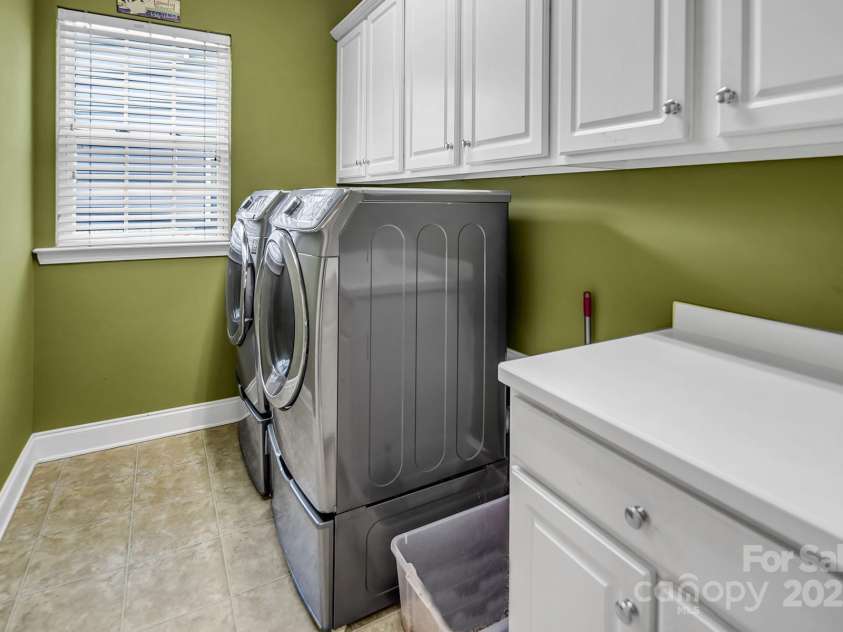10792 Elsfield Avenue, Concord, NC 28027.  MLS# CAR4261572, YatesRealty ID 19040. Large laundry room with lots of storage