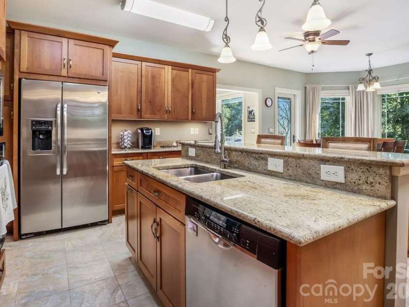 301 Gateway Drive, Hendersonville, NC 28739.  MLS# CAR4373962, YatesRealty ID 19050. Spacious kitchen with three sinks and large walk-in pantry.