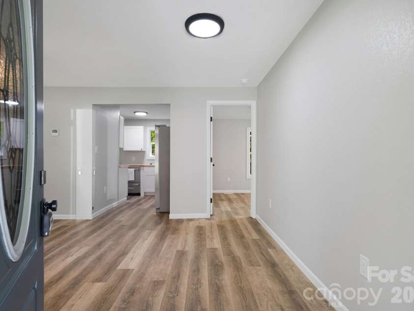 95 Grassy View Road, Candler, NC 28715.  MLS# CAR4283278, YatesRealty ID 19056. Enter into the spacious living room!
