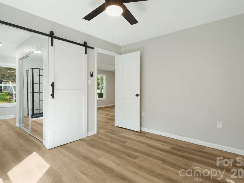 95 Grassy View Road, Candler, NC 28715.  MLS# CAR4283278, YatesRealty ID 19056. Stylish barn door for the primary bathroom!