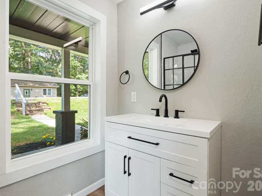 95 Grassy View Road, Candler, NC 28715.  MLS# CAR4283278, YatesRealty ID 19056. Vanity in primary bathroom