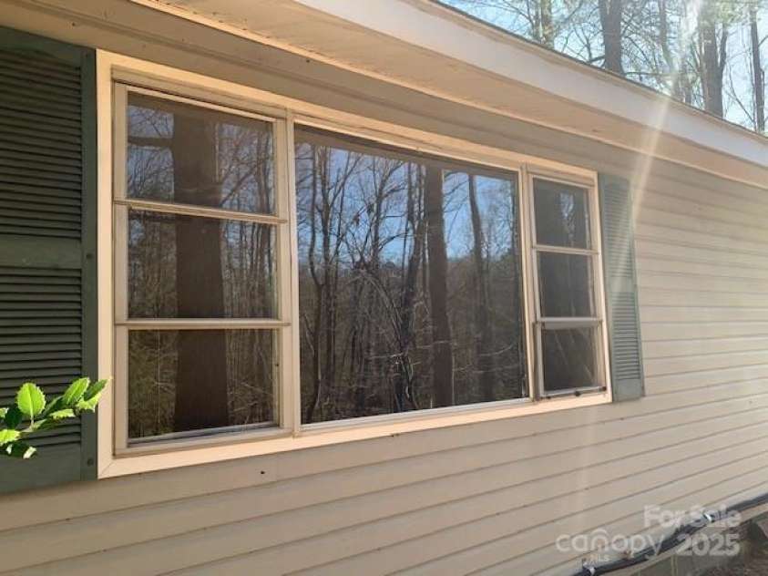 60 LAKEMONT COTTAGE Trail, Flat Rock, NC 28739.  MLS# CAR4233288, YatesRealty ID 1907. LIVING ROOM TO LAKE, GAZEBO, LONG VIEW